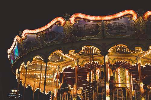carousel orange carousel ride during night time theme park
